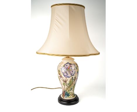 A Moorcroft 'Meadow Cranesbill' pattern baluster lamp, designed by Phillip Gibson, on a wooden base, approx 27cm high (exclud