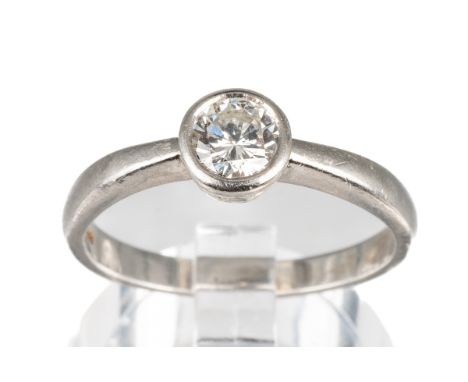 A platinum and diamond solitaire ring, set with a round brilliant-cut diamond approx 0.35ct in a rub-over setting, ring size 