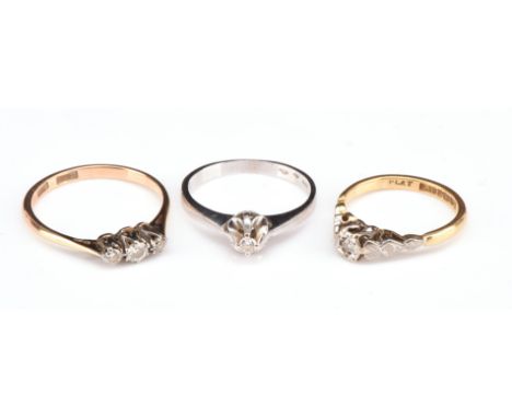 Three diamond rings, including a single stone brilliant cut diamond ring, hallmarked 14 ct, ring size J, a three stone brilli