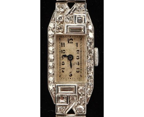 An Art Deco ladies cocktail watch, the rectangular case with diamond set bezel and lugs, the unsigned dial with Arabic numera
