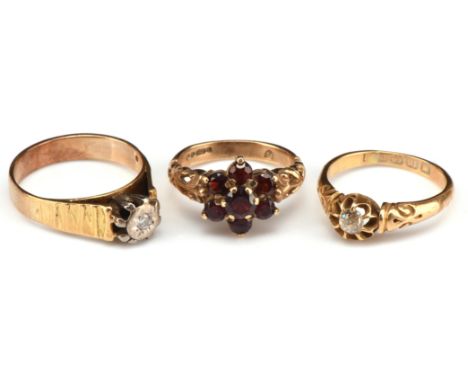 Two Victorian gem set rings and a diamond single stone ring, including a red paste daisy cluster ring with openwork scroll sh