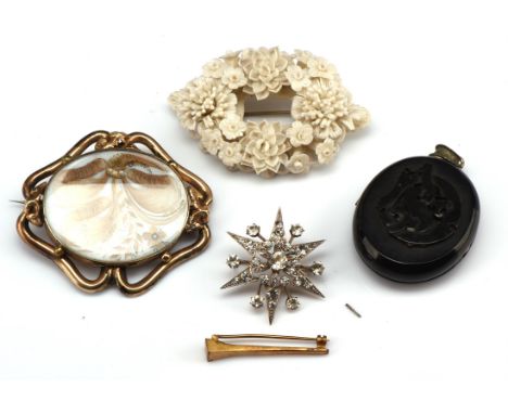 Four antique brooches and a locket, a large hairwork brooch with floral design, in a scroll mount of gilt metal, measuring 65