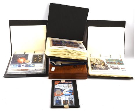 A collection of largely uncirculated world coins in four albums and a bespoke hard wooden display case. One album contains fo