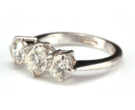 Diamond three stone ring, set with round brilliant cut diamonds in a claw setting, central diamond approx. 0.87 carats, with 