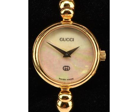 Gucci a Ladies reference 2700 L, gold plated bangle wristwatch, with mother of pearl dial, fitted with quartz movement and mo