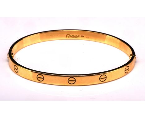 Cartier 'Love' bangle, of oval form with screw head motifs, signed Cartier, original fastening screwdriver system internal me