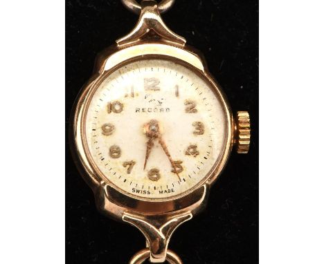 A ladies Record gold wrist watch, signed dial with Arabic numerals and manual wind movement the round case, stamped 9 ct, wit