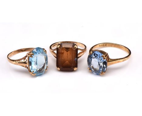 Three gem set rings in 9 ct yellow gold, including an oval synthetic blue spinel, ring size N1/2, an oval blue paste ring siz