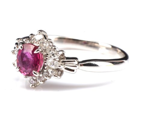 Ruby and diamond ring, set with an oval cut central ruby estimates as 0.55 carats, surrounded by marquise, step cut and round