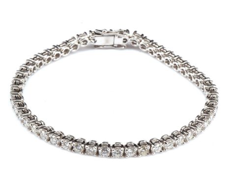 Diamond tennis bracelet, measures 17cm long, estimated total diamond weight 3.80 carats, with concealed clasp and safety clip