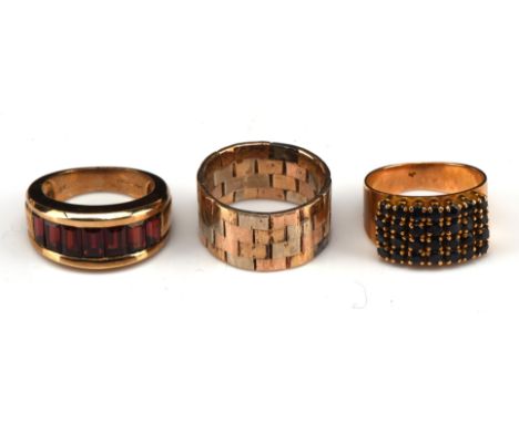 Three vintage rings, including a sapphire four row ring, stamped 18 ct, ring size I, a 1970's tri coloured brick link ring, i