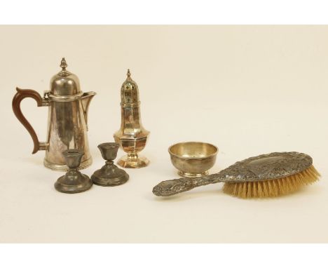 A silver water pot together with a silver sugar basin, a repousse decorated hairbrush, a pair of dwarf candlesticks and a sug