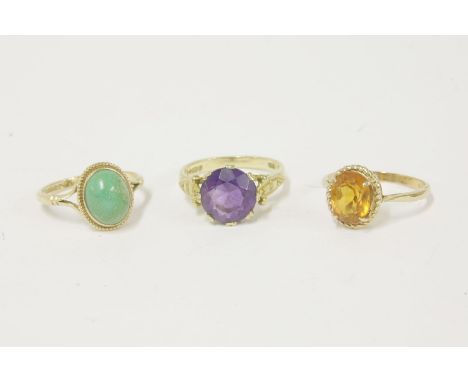 A 9ct gold single stone amethyst ring, a 9ct gold single stone citrine ring, and a 9ct gold turquoise cabochon ring