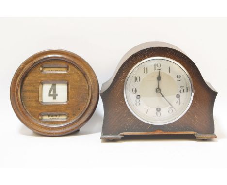 A1930's oak cased mantel clock, together with a mahogany cased wall calendar