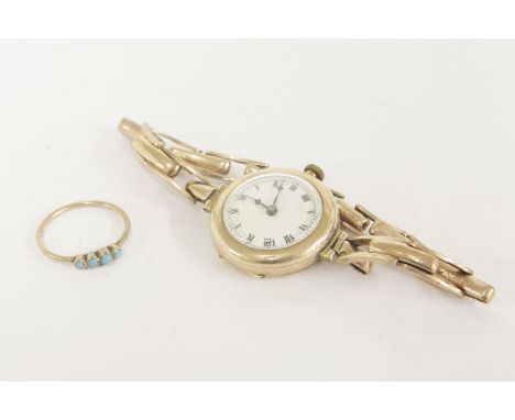 A ladies 9ct gold mechanical bracelet watch, white enamel dial with Roman numerals, a gold four stone turquoise ring, a gilt 