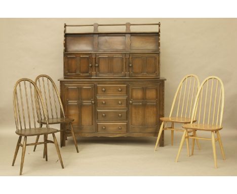 An Ercol sideboard, wall cupboard, and four chairs