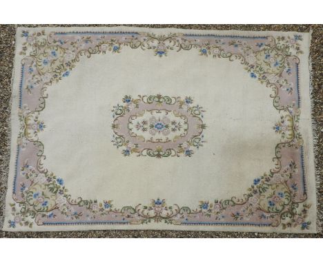 A large, possibly French, carpet, cream ground decorated with floral motifs