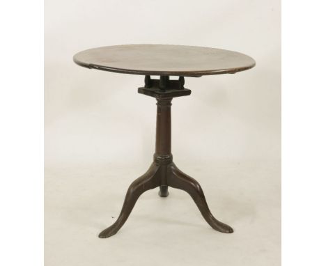 A George III mahogany tripod table, the circular top on birdcage and gun barrel column descending onto downswept supports, 76