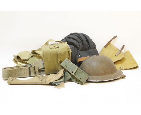 A military issue tank helmet, together with one other helmet, and a small collection of military items