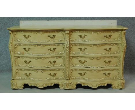 a mid century vintage cream and gilt bombe style chest of drawers fitted with an arrangement of eight drawers on shaped brack