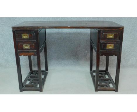 A 19th century Chinese teak three section pedestal desk fitted with two drawers to each side above pierced undertier. H.80 W.