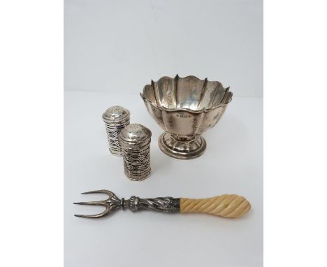 A pair of geometric pierced silver salt and pepper shakers with other items. The salt and pepper shakers have a Bristol blue 