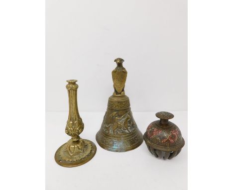 An antique brass bell along with an Indian elephant bell and brass repousse candle stick base. The bell handle is in the form