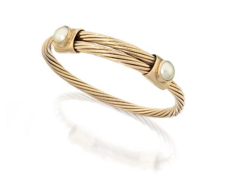 A 9 Carat Gold Split Pearl Bangle, the yellow rope twist bangle terminating to plain polished bars inset with split pearls, i
