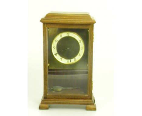 AN OAK MANTEL CLOCK