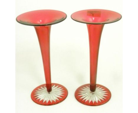 A PAIR OF RUBY CASED GLASS TRUMPET VASES ON STAR CUT FOOT