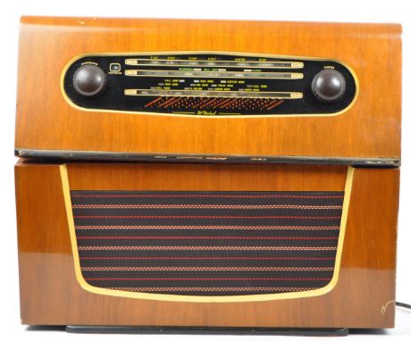 A vintage mid 20th century (circa 1953) radio valve and record player. A McMichael 545 valve radio with Monarch UA8 four spee