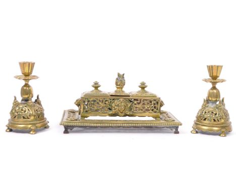 A late Victorian brass inkstand fitted with two round white / pink moulded glass inkwells and incorporated stamp tray. The st