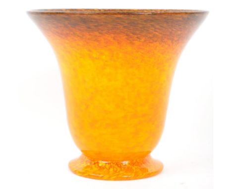 A vintage 20th century studio art glass bottle vase by Monart. Having a tapered body with mottled orange colourway. Signed / 