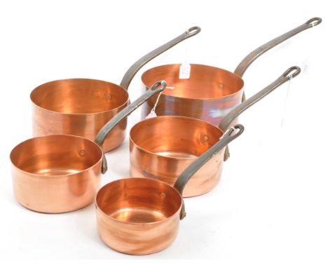 A collection of five graduated copper pans / pots (possibly French) with iron handles, complete with original oak hanging she