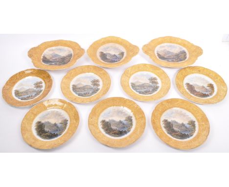 A collection of 19th century Victorian ceramic dinner plates and tazzas. Depicting a mountainous river side scene with gilt d