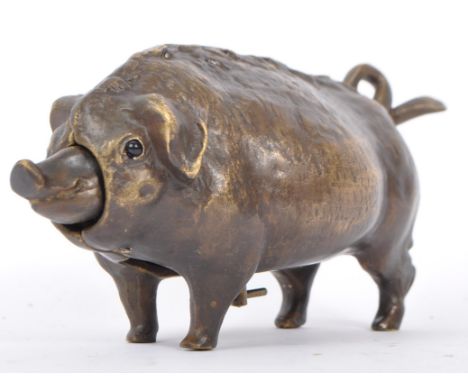 A bronze desk bell in the form of a pig, the underbelly having wind up key with snout and tail influencing bell ring. Measure