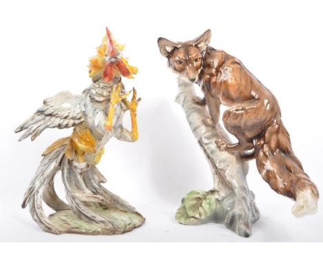 Two pieces of vintage 20th century Italian Tay porcelain to include a fox perched on branch and a fighting cockerel. A/F. Mea
