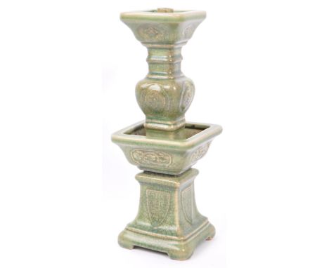 A large 19th century Chinese Wacai Gu form archaic style ceramic green glazed candlestick. The candlestick having green crack