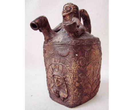 An early South American possibly Mayan pottery jug, hand thrown, of square sided form, the neck as a Tribesman torso holding 