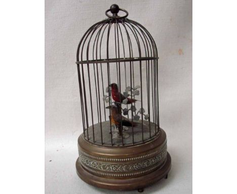 An early 20th century Automaton, a pair of clockwork singing birds in a brass cage, possibly French, 28cm tall 