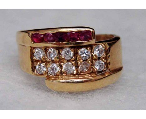 A modern 18ct gold ruby and white stone dress ring set with two bands of five clear stones overlapped by a band of five small