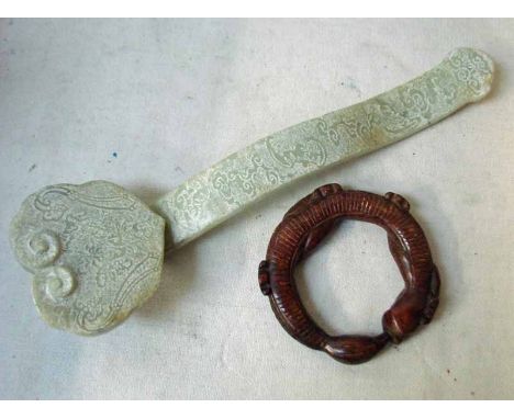 A large carved Chinese jade/hardstone Ruyi with engraved stylised foli, 39cm long and a hardstone bracelet as a coiled dragon