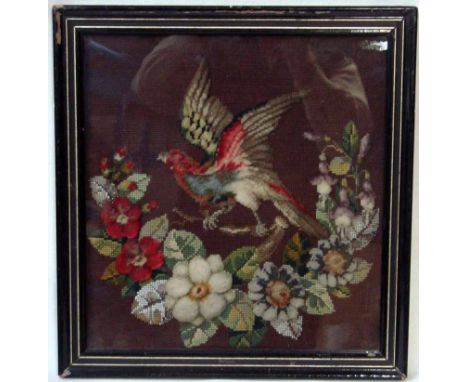 A 19th century stump work and bead work tapestry depicting an exotic bird on a flowering branch, on a brown wool embroidered 