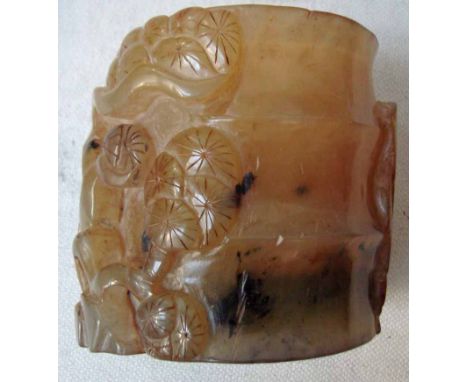 A Chinese jade/hardstone brush pot carved in relief with flowering trees and bamboo, 10cm high 