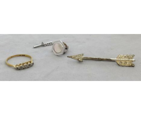 An 18ct five stone ring set with small diamonds, an arrow brooch, mother of pearl tie pin stud.