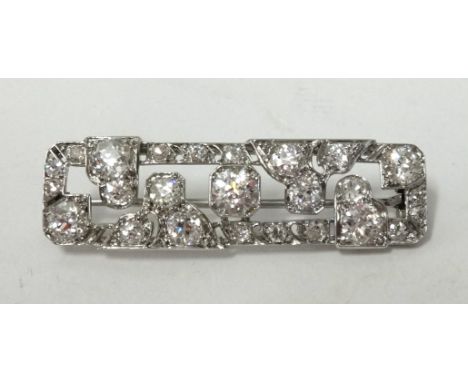 A fine art deco platinum and diamond bar brooch set with an arrangement of round old cut diamonds, length approx 42mm, width 