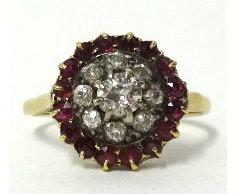 An antique diamond and ruby cluster ring set in yellow metal, (unhallmarked), diameter approx 12mm, finger size N.