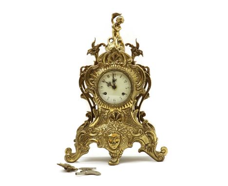 A cast brass mantel clock,20th century, in the Rococco taste, the painted enamel dial, bearing the name 'Walt', striking on t