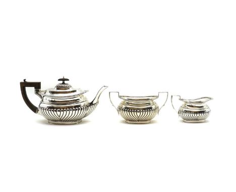 A silver three piece tea service, by William Aitken, Birmingham 1905, comprising a teapot, 14.5cm high, sugar bowl, 10cm high