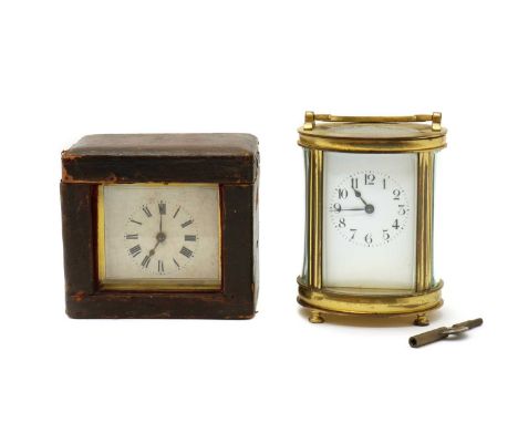 A oval brass carriage clock,French, in bevelled glass case,13cm highand a further carriage clock,in leather travel case,11cm 